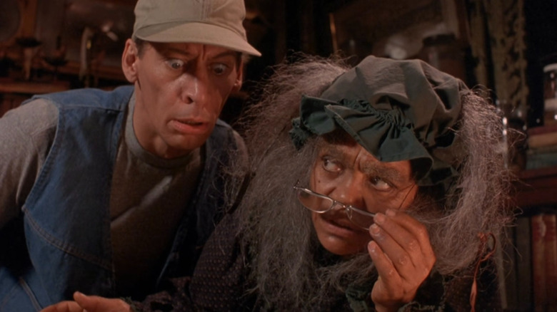 Ernest looking over Old Lady Hackmore's shoulder in Ernest Scared Stupid