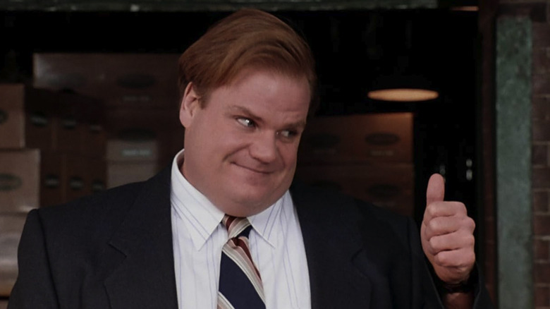 Chris Farley's Tommy wearing a suit and giving a thumbs up at the end of Tommy Boy