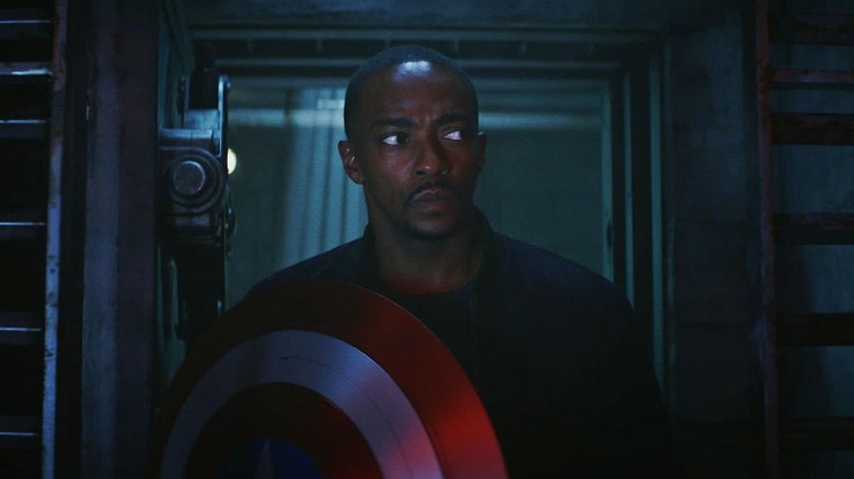 Anthony Mackie as Sam Wilson holding Cap's shield entering The Leader's bunker in Captain America: Brave New World