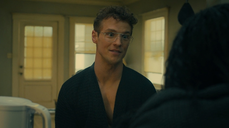 Freddie Stroma as Adrian Chase/Vigilante in season 2 of Peacemaker, wearing a robe and getting hype about crows