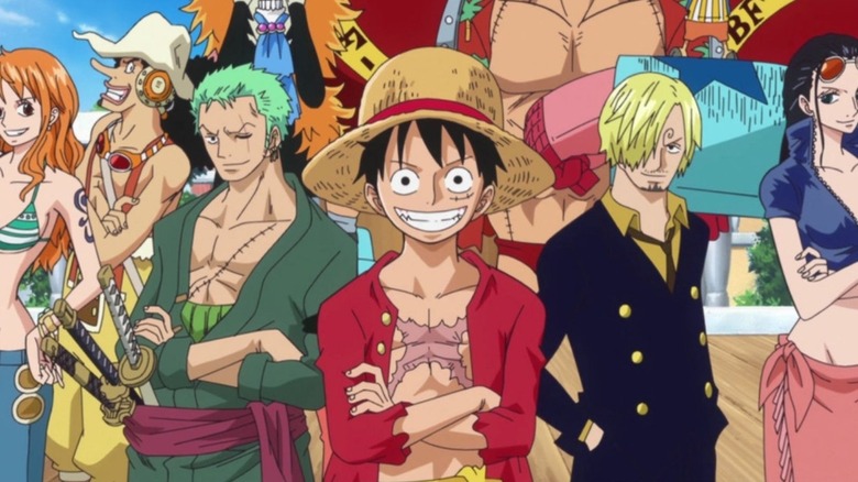 Luffy surrounded by the straw hats in One Piece