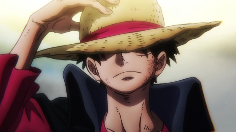 Luffy grabbing his straw hat and looking mighty badass in One Piece