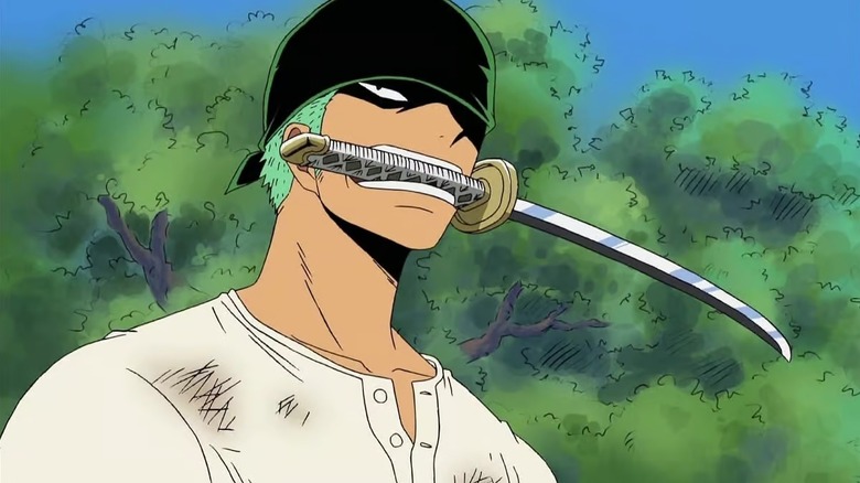 A dirtied Roronoa Zoro holds a sword in his mouth on One Piece