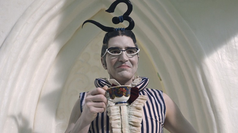 Mr. 3 holds a tea cup while smirking at someone offscreen in One Piece