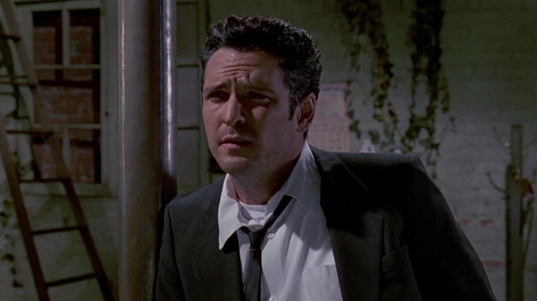 Mr. Blonde leaning against a support beam in Reservoir Dogs
