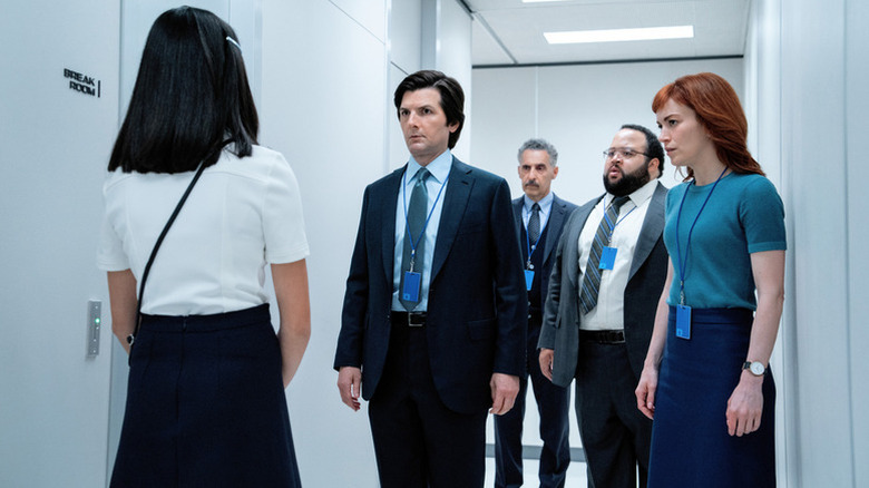 Adam Scott's Mark, Britt Lower's Helly, Zach Cherry's Dylan, and John Turturro's Irving facing Sarah Bock's Miss Huang on Severance