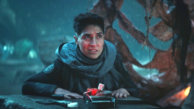 Melissa Navia as Ortegas on Star Trek: Strange New Worlds, leaning over a homemade translator