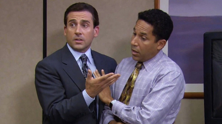 Steve Carell's Michael Scott stands entangled with Oscar on The Office