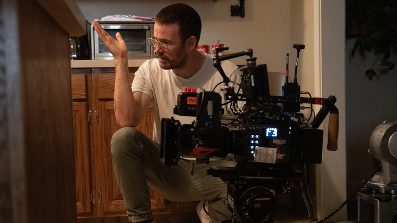 Zach Cregger stood by a camera in a kitchn