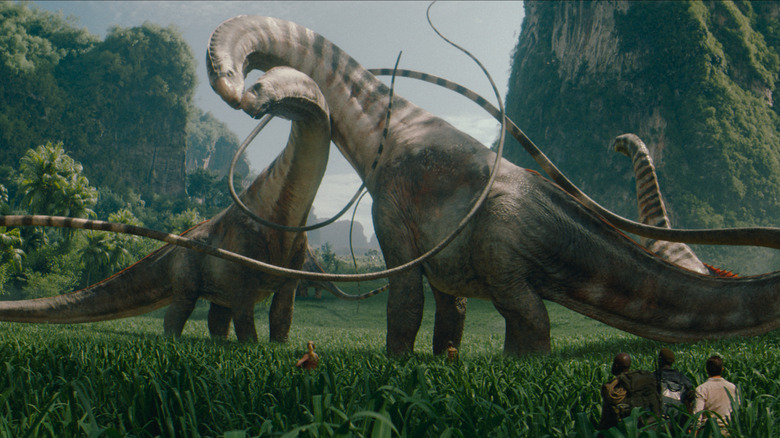 A herd of giant Titanosaurus graze in a valley in Jurassic World Rebirth