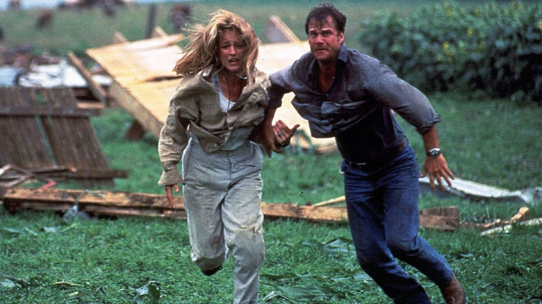 Jo and Bill in a panic, running away from some bad weather in Twister.