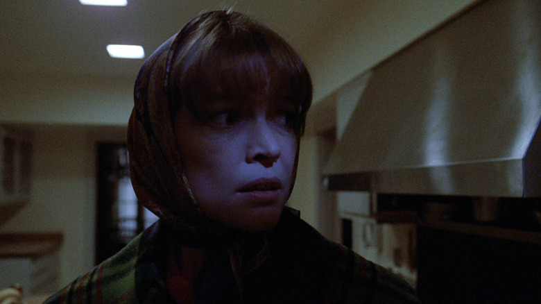 Ellen Burstyn as Chris looking nervous in her kitchen in The Exorcist