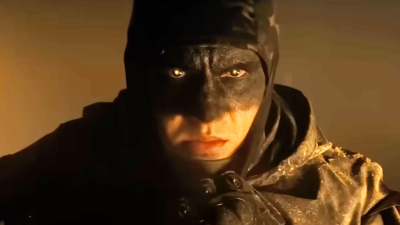 Alex Pereira as The Butcher pulling up his mask in Onslaught