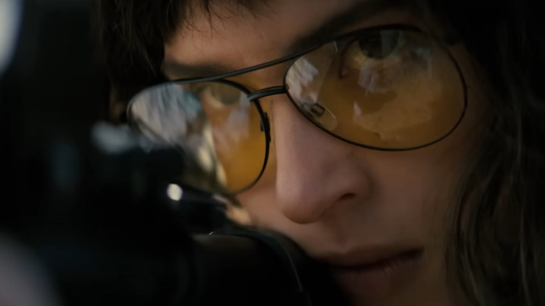 Adria Arjona as Celeste looking down the scope of her gun in Onslaught