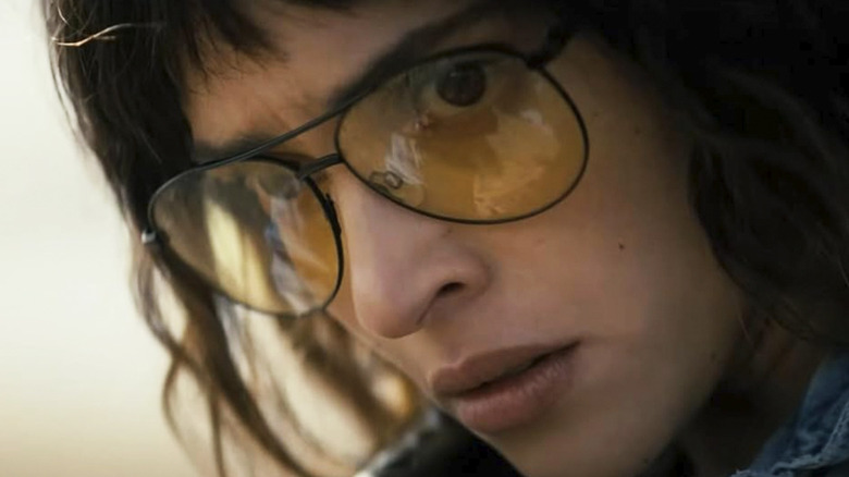 Celeste stares down her target while wearing yellow tinted sunglasses in Onslaught