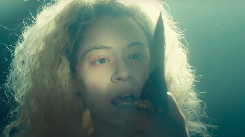 Tatiana Maslany as Helena observing a knife in Orphan Black
