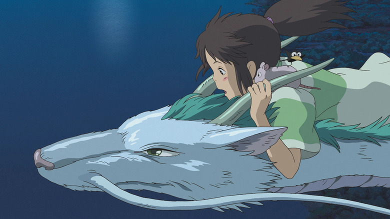 Chihiro, Boh, and Haedori ride Haku, the White Dragon, in Spirited Away