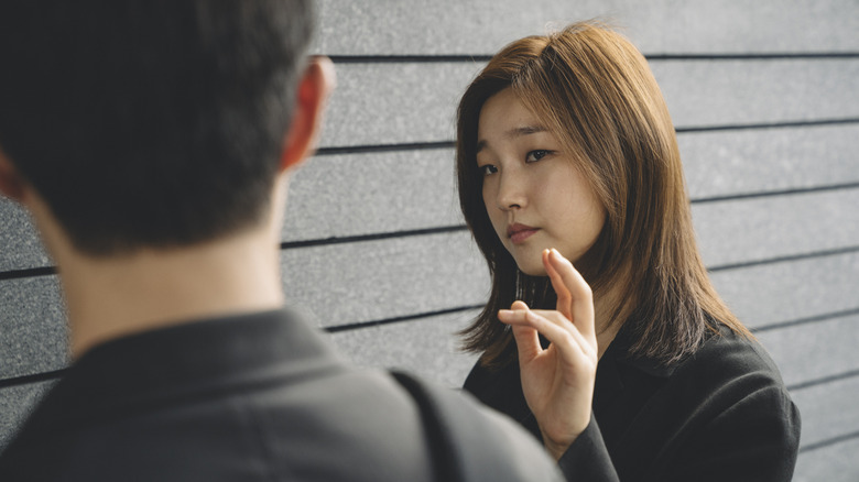 Kim Ki-jung gestuing to her brother in Parasite