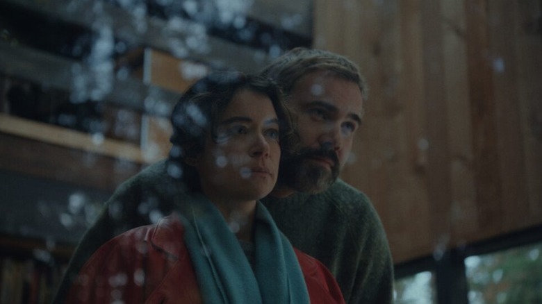 Liz and Malcolm stare out the window ominously in Keeper