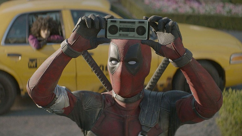 Deadpool holds tiny radio