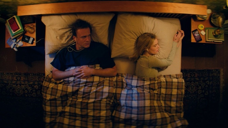 Dan and Lisa looking sad in bed in Over Your Dead Body