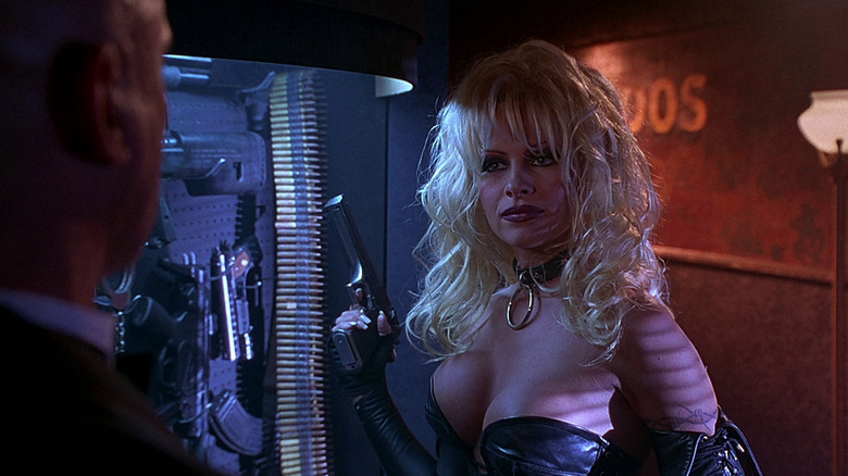 Barb holding a gun in Barb Wire