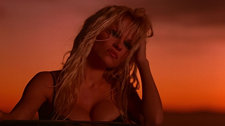 Barb (Pamela Anderson) takes in a sunset view of the apocalypse in Barb Wire.