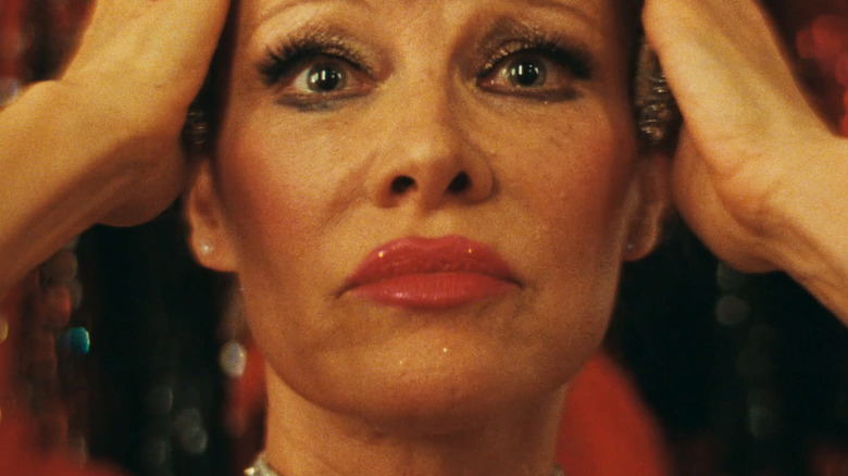 Pamela Anderson as Shelly Gardner holds her hands to her head in The Last Showgirl