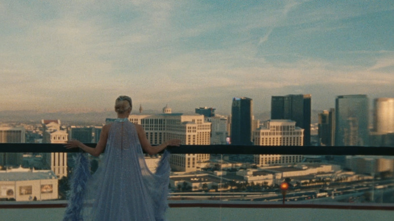 Pamela Anderson in the role of Chile Gardner stands on a balcony overlooking Las Vegas in the last exhibition