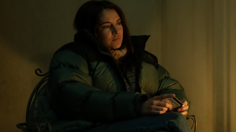 Shailene Woodley as Annie bundled up in a parka and sitting in a chair in Paradise season 2
