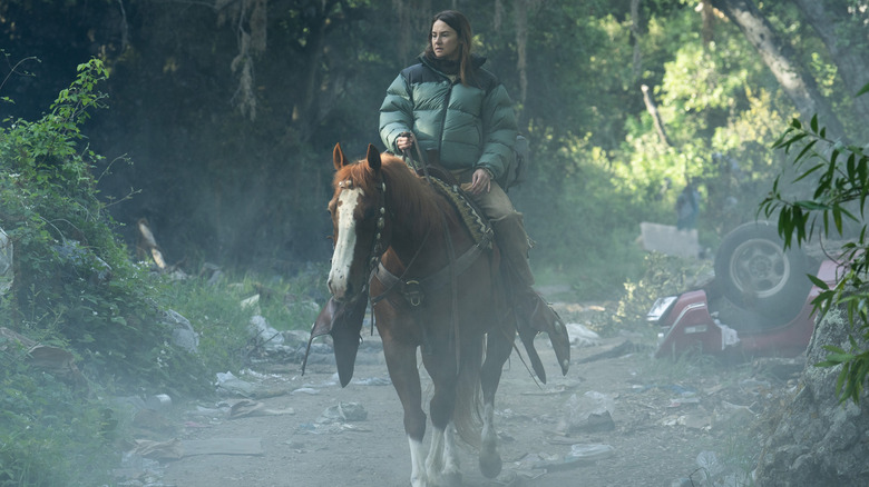 Shailene Woodley as a new character riding a horse through a forest path in Paradise season 2