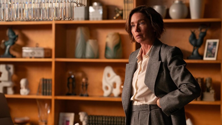 Julianne Nicholson as Samantha Redmond wearing a suit and standing in an office in Paradise