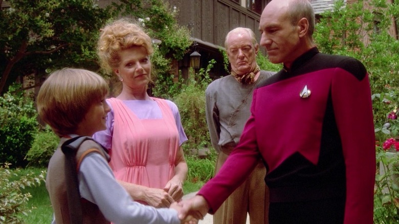 Picard shaking Rene's hand as Robert and his wife look on on Star Trek: The Next Generation