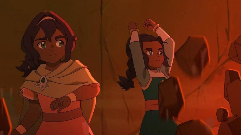 Pavi looks as Nisha lifts some rocks using earthbending in Avatar: Seven Havens
