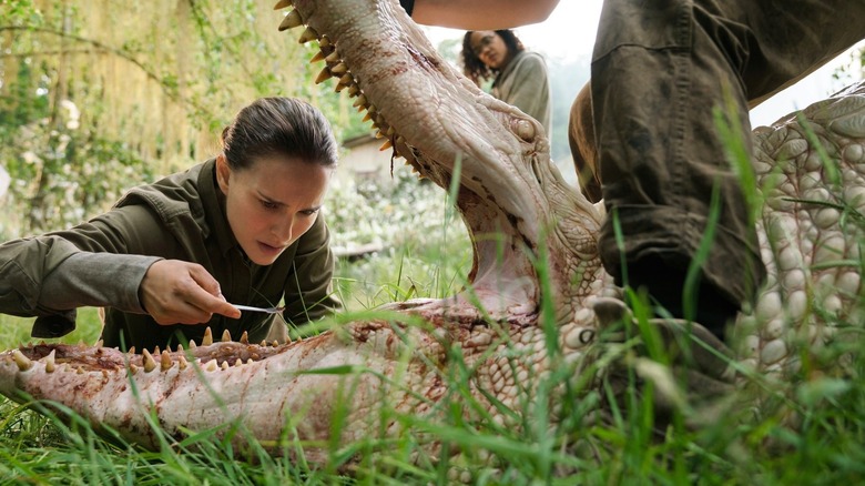 Lena poking a dead crocodile in the mouth in Annihilation