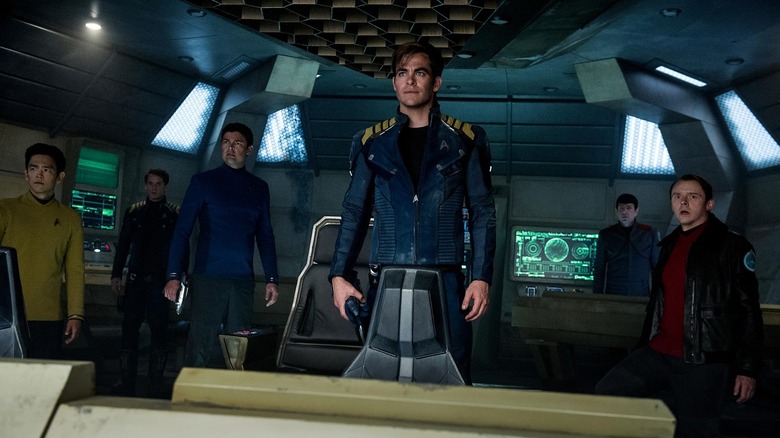 Captain Kirk standing on the bridge, surrounded by his crew, in Star Trek Beyond