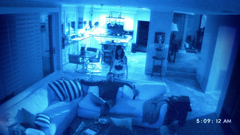 Katie Featherston standing behind Brian Boland in Paranormal Activity 2