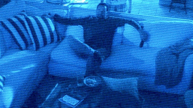 Brian Boland sitting on the couch in Paranormal Activity 2