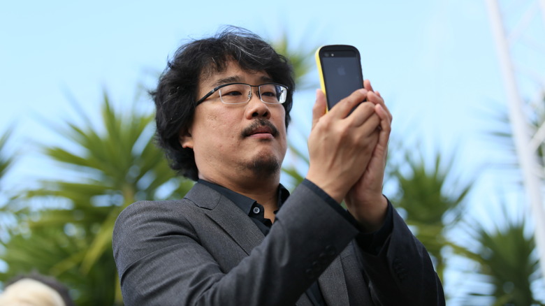 Bong Joon-ho using his phone