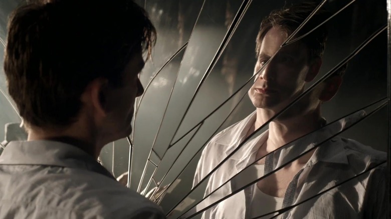 David Tennant as Hamlet staring at his reflection in a shattered mirror in Hamlet (2009)