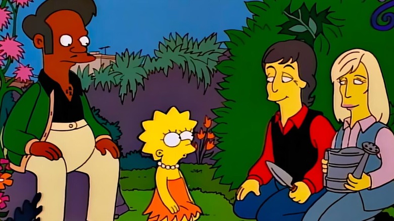 Apu, Lisa Simpson, Paul McCartney, and Linda McCartney sit together in 