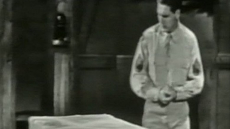 Sergeant Wilson next to a mysterious cube in Tales of Tomorrow
