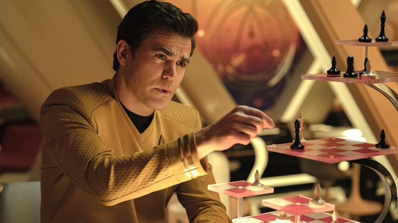 Paul Wesley as James T. Kirk moving a chess piece across a board in Star Trek: Strange New Worlds