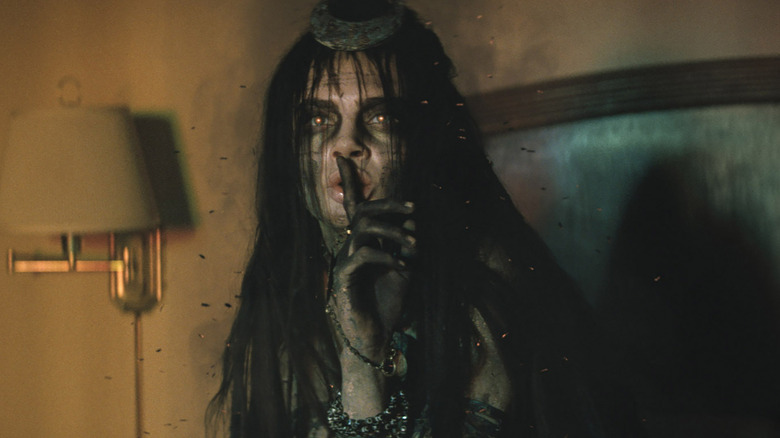 Enchantress making a quiet sign in Suicide Squad
