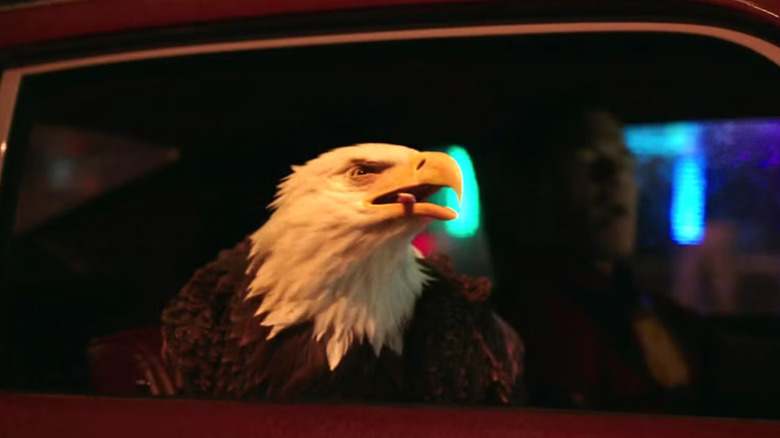 Eagly hanging its head out of the car window on Peacemaker