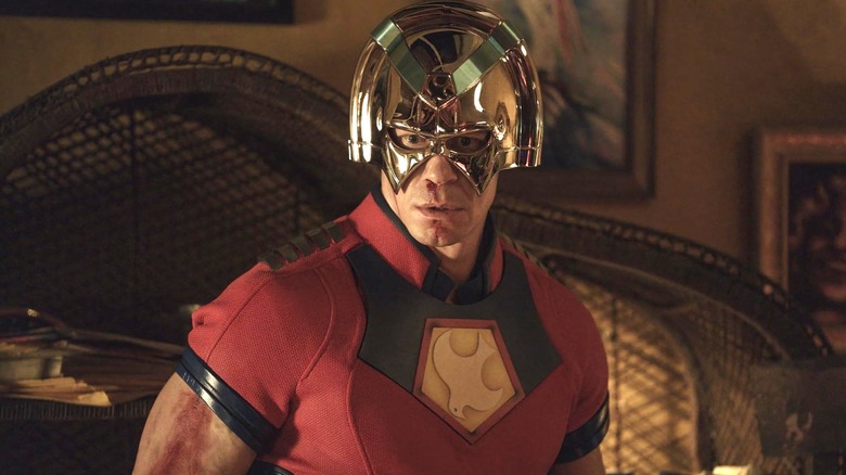 Peacemaker wearing his helmet, looking at something off camera