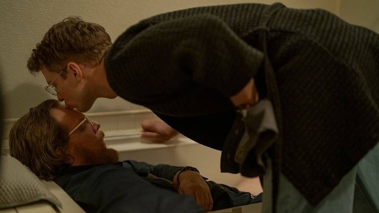 Freddie Stroma as Adrian Chase/Vigilante gives Steve Agee as John Economos a little kiss on the forehead while he sleeps on Peacemaker