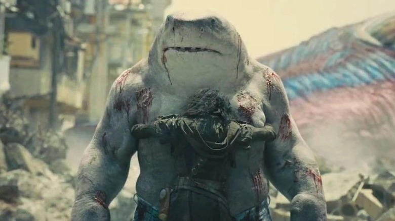 Danielo Melchior as Ratcatcher 2 giving King Shark a big hug in The Suicide Squad