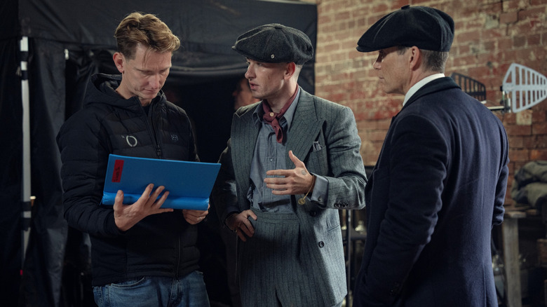 Director Tom Harper talking to actors Barry Keoghan as Duke Shelby and Cillian Murphy as Tommy Shelby on the set of Peaky Blinders: The Immortal Man