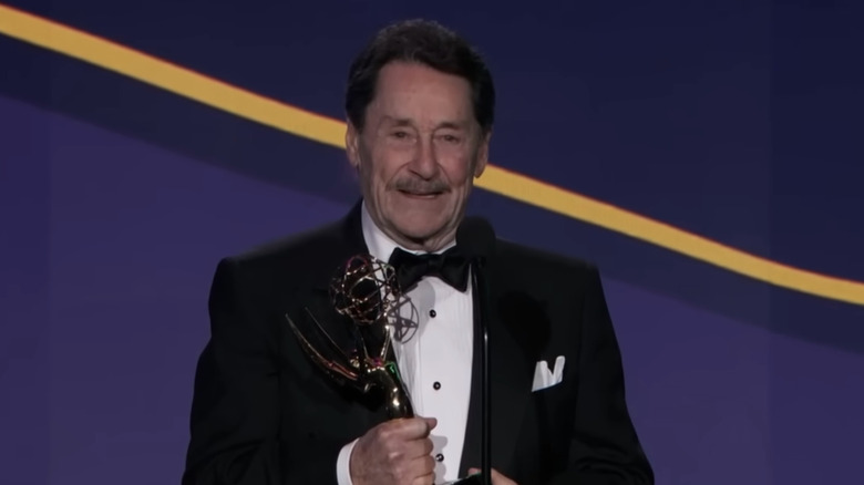Peter Cullen holding lifetime achievement award